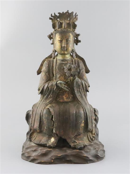 A Chinese lacquered bronze seated figure of Xi Wangmu, late Ming dynasty, H. 38cm including later wood stand
